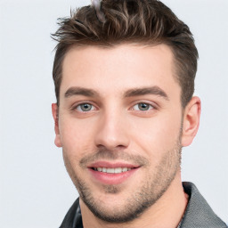 Joyful white young-adult male with short  brown hair and grey eyes