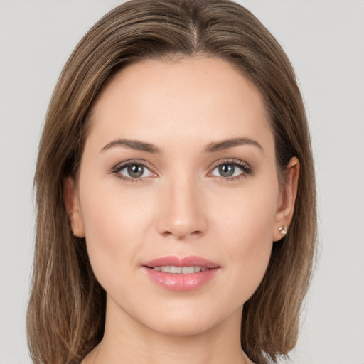 Joyful white young-adult female with long  brown hair and grey eyes