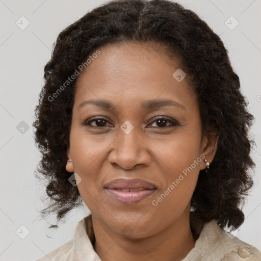 Joyful black adult female with medium  brown hair and brown eyes