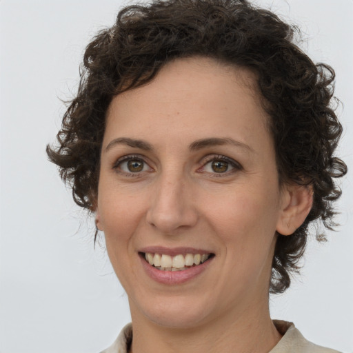 Joyful white adult female with medium  brown hair and green eyes