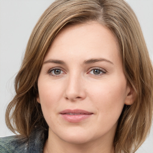 Joyful white young-adult female with medium  brown hair and green eyes