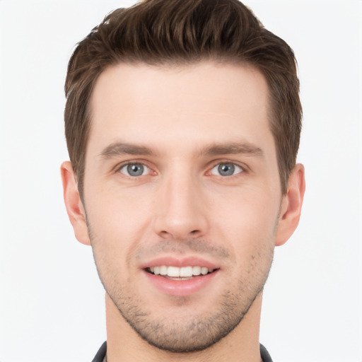 Joyful white young-adult male with short  brown hair and grey eyes