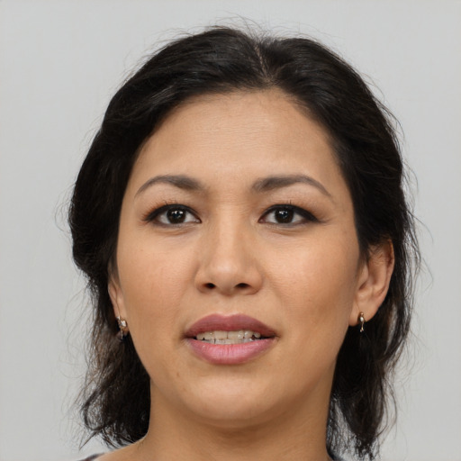 Joyful asian adult female with medium  brown hair and brown eyes