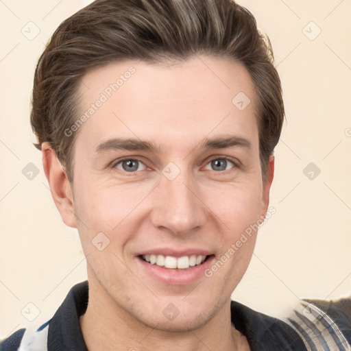 Joyful white young-adult male with short  brown hair and grey eyes