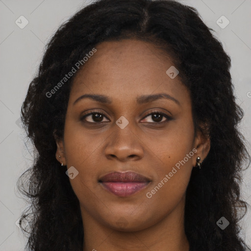 Joyful black young-adult female with long  brown hair and brown eyes