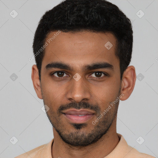 Joyful latino young-adult male with short  black hair and brown eyes