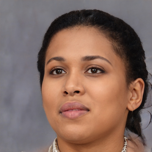 Joyful black young-adult female with short  brown hair and brown eyes