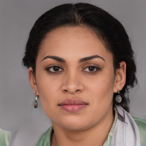 Joyful latino young-adult female with short  brown hair and brown eyes
