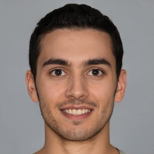 Joyful white young-adult male with short  brown hair and brown eyes