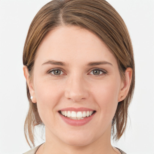 Joyful white young-adult female with medium  brown hair and grey eyes