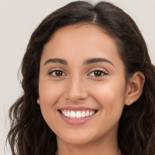 Joyful white young-adult female with long  brown hair and brown eyes