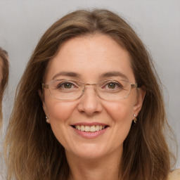 Joyful white adult female with long  brown hair and brown eyes