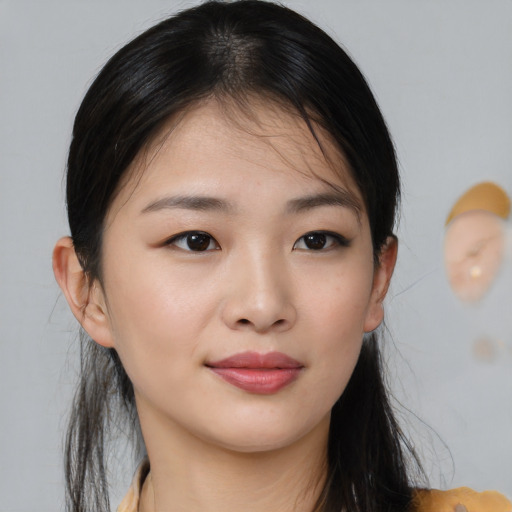 Joyful asian young-adult female with medium  brown hair and brown eyes