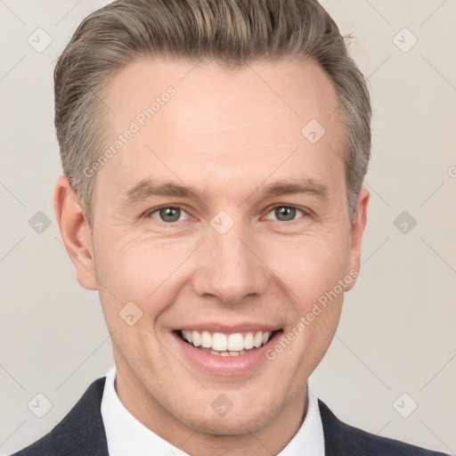 Joyful white adult male with short  brown hair and grey eyes