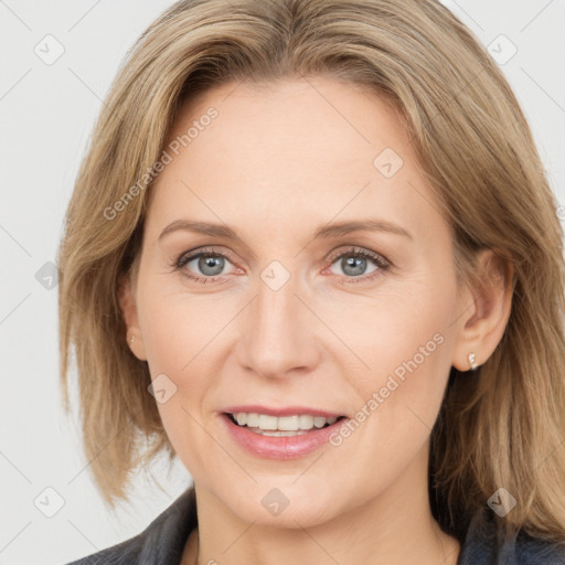 Joyful white adult female with medium  brown hair and grey eyes