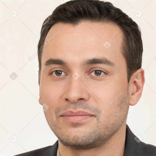 Joyful white young-adult male with short  brown hair and brown eyes