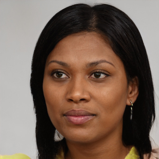 Joyful black young-adult female with medium  black hair and brown eyes