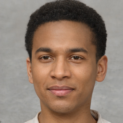 Joyful latino young-adult male with short  brown hair and brown eyes