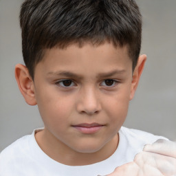 Joyful white child male with short  brown hair and brown eyes