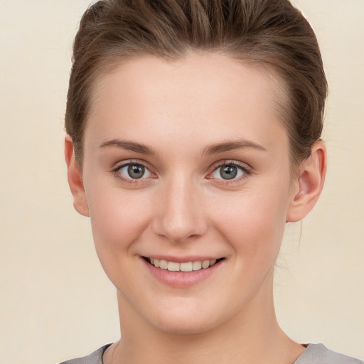 Joyful white young-adult female with short  brown hair and brown eyes