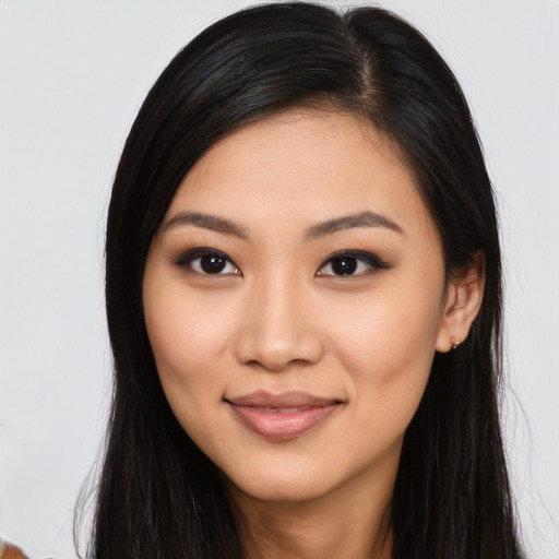 Joyful asian young-adult female with long  brown hair and brown eyes