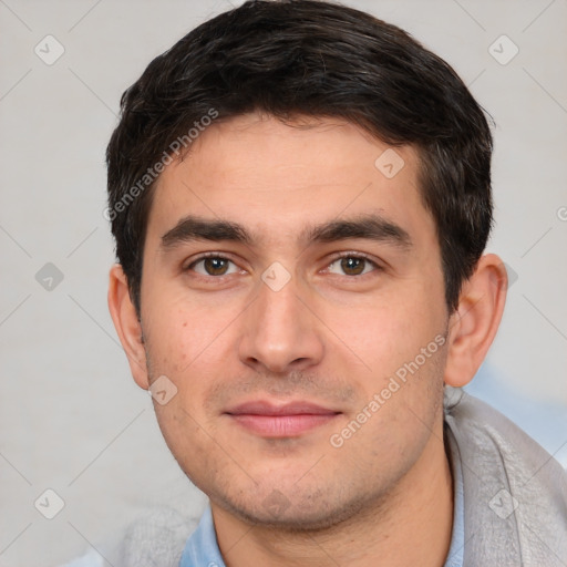 Joyful white young-adult male with short  black hair and brown eyes