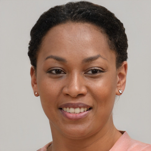 Joyful black young-adult female with short  brown hair and brown eyes