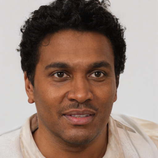 Joyful black young-adult male with short  brown hair and brown eyes