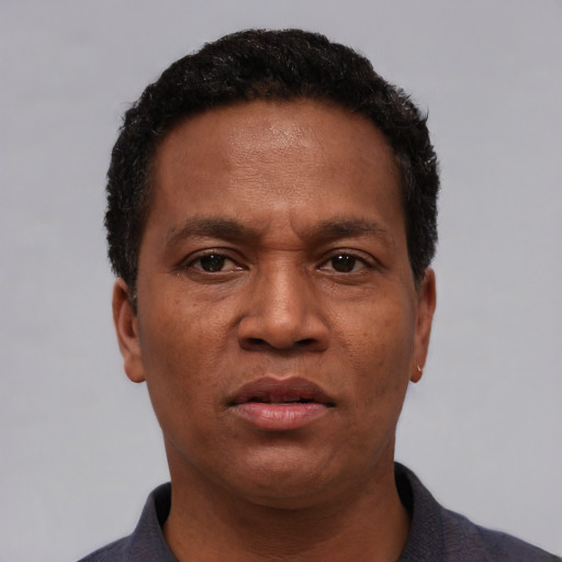 Neutral latino adult male with short  black hair and brown eyes