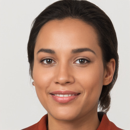 Joyful latino young-adult female with long  brown hair and brown eyes