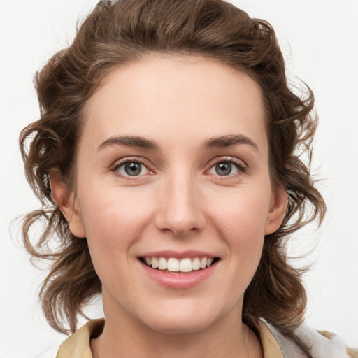 Joyful white young-adult female with medium  brown hair and blue eyes