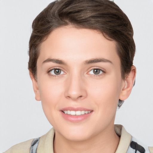 Joyful white young-adult female with short  brown hair and grey eyes