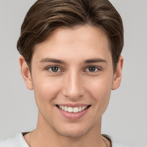 Joyful white young-adult female with short  brown hair and grey eyes