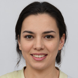 Joyful latino young-adult female with medium  brown hair and brown eyes