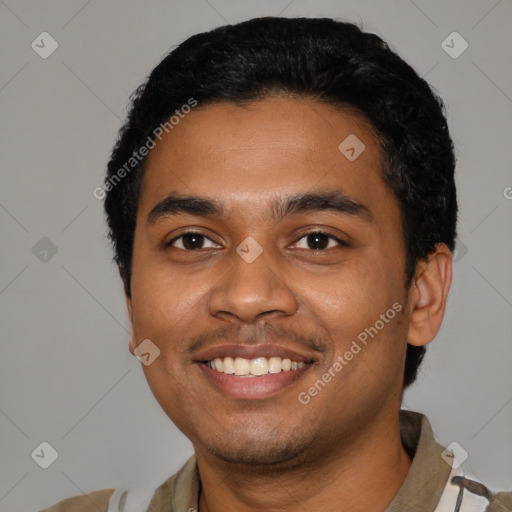 Joyful black young-adult male with short  black hair and brown eyes