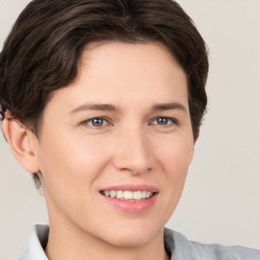 Joyful white young-adult female with short  brown hair and brown eyes