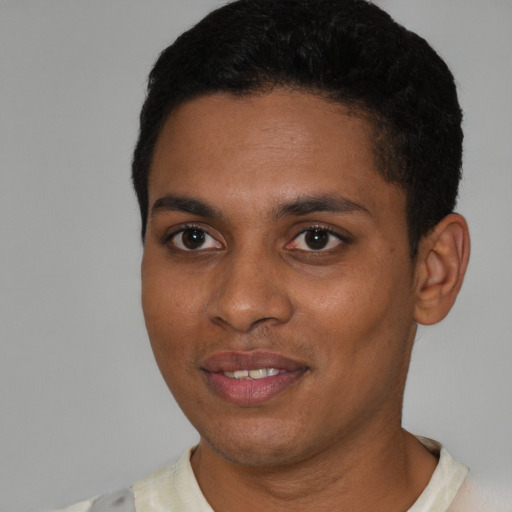 Joyful latino young-adult male with short  brown hair and brown eyes