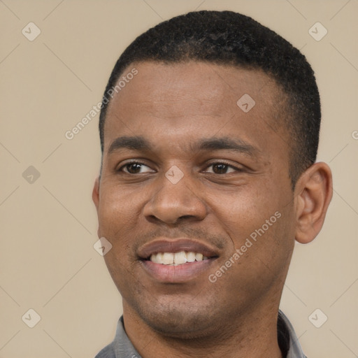 Joyful black young-adult male with short  black hair and brown eyes