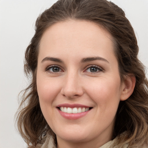 Joyful white young-adult female with long  brown hair and grey eyes