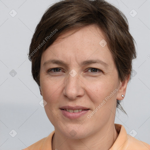 Joyful white adult female with short  brown hair and grey eyes