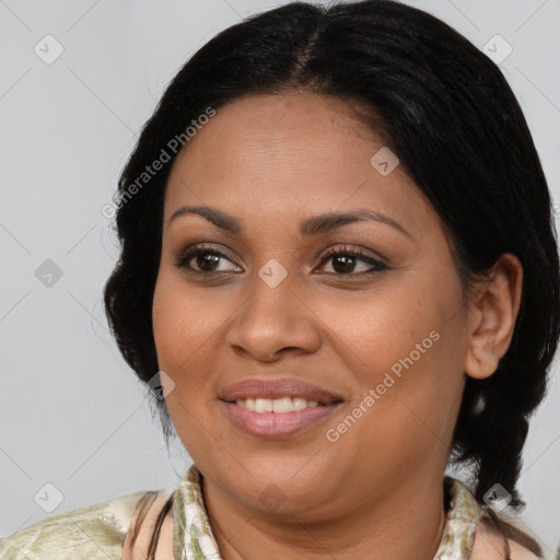 Joyful latino adult female with medium  brown hair and brown eyes