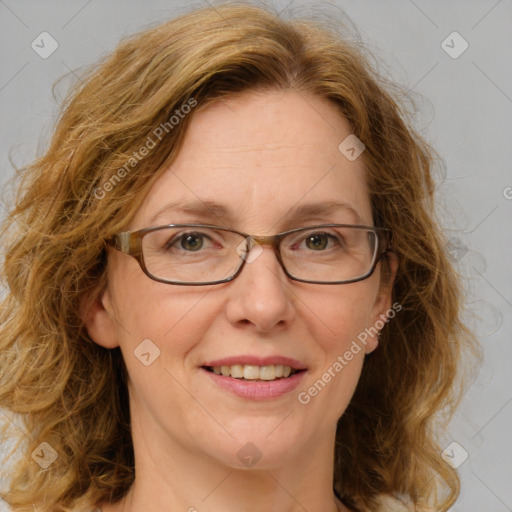 Joyful white adult female with medium  brown hair and blue eyes