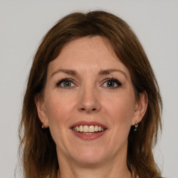 Joyful white adult female with medium  brown hair and grey eyes