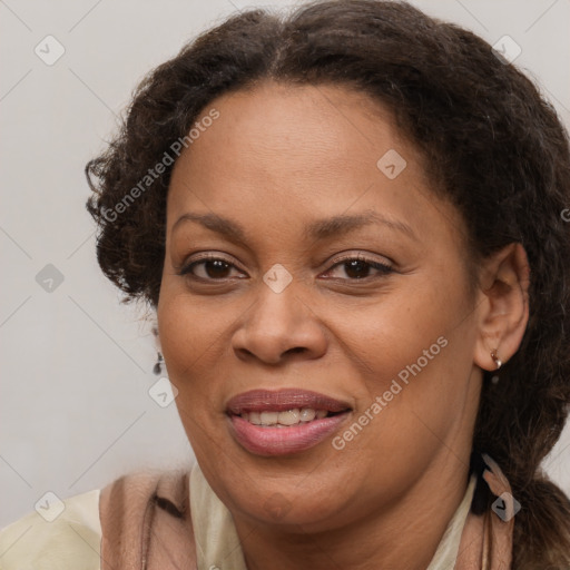 Joyful black adult female with medium  brown hair and brown eyes