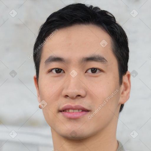 Joyful asian young-adult male with short  black hair and brown eyes