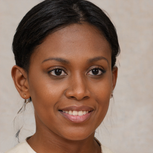 Joyful black young-adult female with medium  brown hair and brown eyes