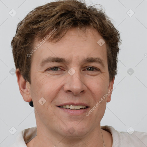 Joyful white adult male with short  brown hair and grey eyes