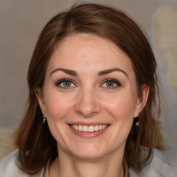 Joyful white adult female with medium  brown hair and brown eyes