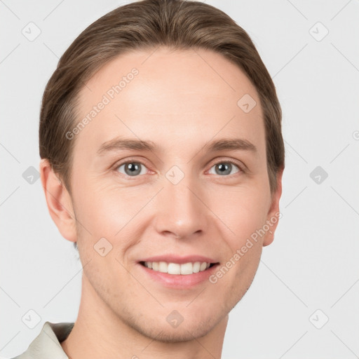 Joyful white young-adult male with short  brown hair and grey eyes