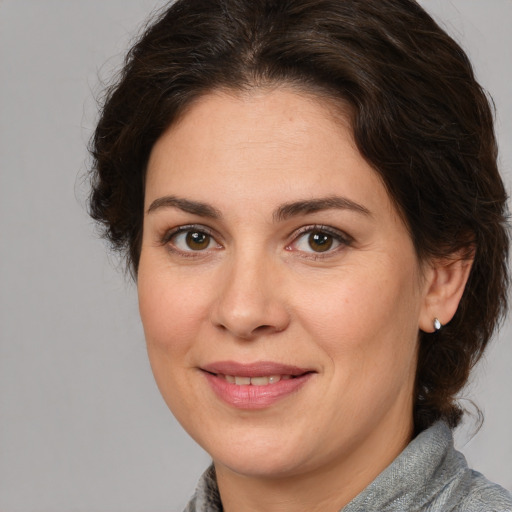 Joyful white adult female with medium  brown hair and brown eyes